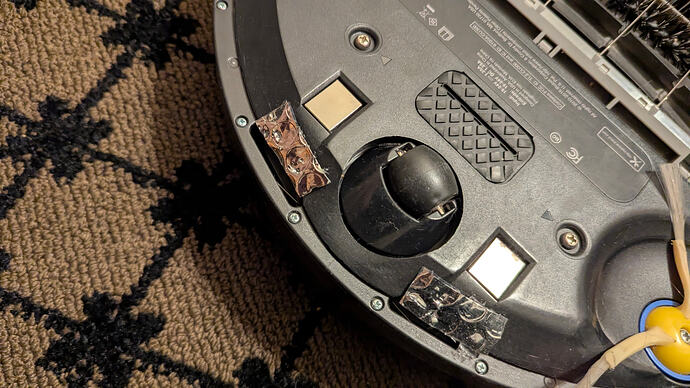 Adhesive double-sided foil bubble wrap over two of the four cliff sensors.